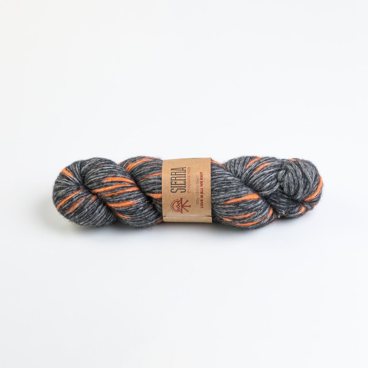 Gray and orange skein of yarn with a label on a white background