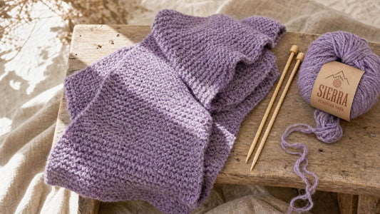 Learn to knit in a weekend finished garter stitch scarf draped on a wooden bench with US 10.5 bamboo needles and Cloudtouch Baby Alpaca Pima Cotton Blend yarn