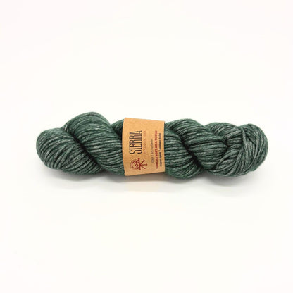 Green skein of yarn with a label on a white background