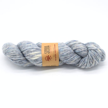Light blue and white skein of yarn with a label on a white background