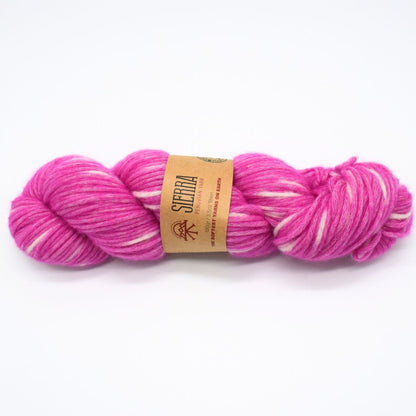 Pink and white skein of yarn with a label on a white background