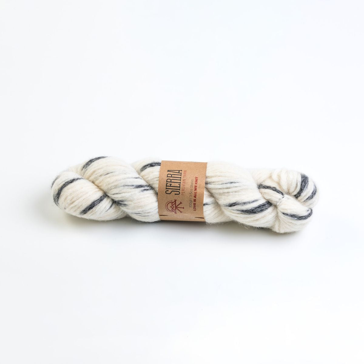 white and charcoal skein of yarn with a label on a white background