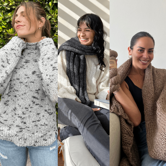 three women showcasing knitted projects