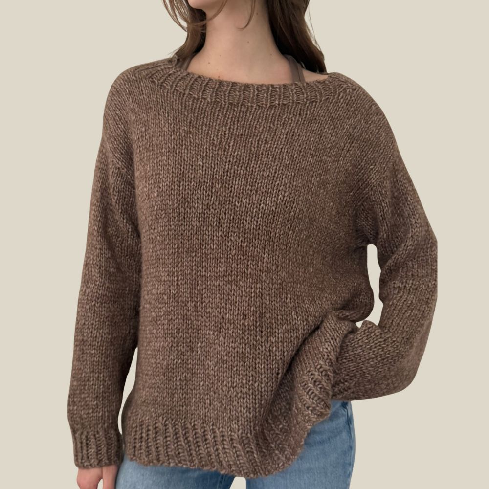 Brown knitted sweater worn by a person on a beige background