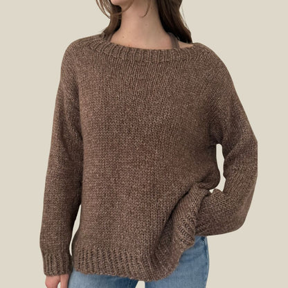 Brown knitted sweater worn by a person on a beige background